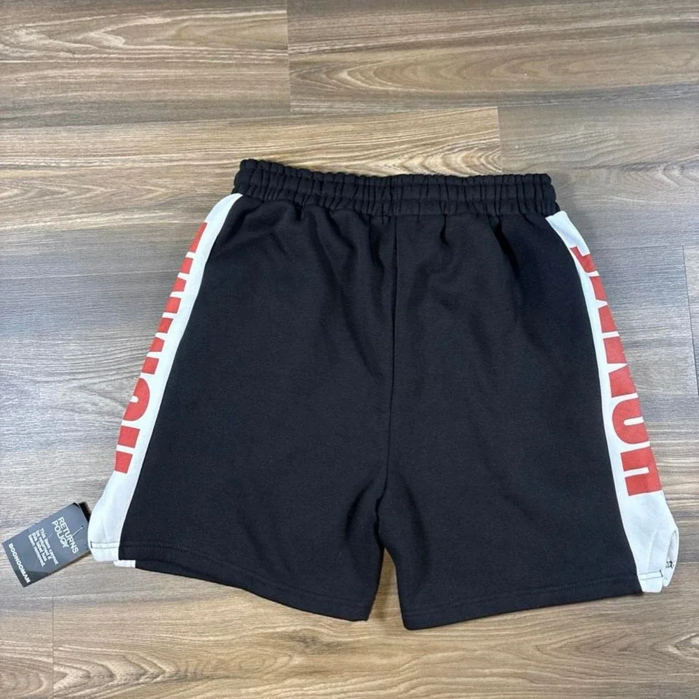 BoohooMAN black shorts with white side panels and red 'HOMME' text, size M
